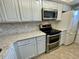 Updated kitchen featuring stainless steel appliances and modern countertops and cabinets at 1 Boca Ciega Point Blvd # 213, St Petersburg, FL 33708