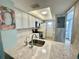Well-lit kitchen with a stainless steel sink, updated appliances, and bright white cabinetry at 1 Boca Ciega Point Blvd # 213, St Petersburg, FL 33708
