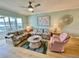 Comfortable living room featuring floral sofas and a cozy armchair, creating a welcoming atmosphere at 1 Boca Ciega Point Blvd # 213, St Petersburg, FL 33708