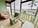 Bright sunroom featuring tile floors, large windows with water views, and comfortable seating at 1 Boca Ciega Point Blvd # 213, St Petersburg, FL 33708
