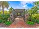 Landscaped courtyard featuring brick pavers, pergola, outdoor seating and an iron gate entry at 101 30Th N Ave, St Petersburg, FL 33704