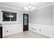 Dining room with decorative window, chandelier, and wainscotting at 101 30Th N Ave, St Petersburg, FL 33704