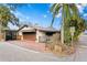 Exterior view of home showcasing brick driveway, iron gates, and lush greenery at 101 30Th N Ave, St Petersburg, FL 33704