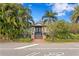 Charming home exterior with brick accents, gated front yard, and tropical landscaping at 101 30Th N Ave, St Petersburg, FL 33704