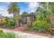 Beautiful front gate with brick columns, lush plants, and unique pergola at 101 30Th N Ave, St Petersburg, FL 33704
