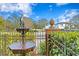 Decorative water fountain, green bushes, and a wrought iron fence at 101 30Th N Ave, St Petersburg, FL 33704