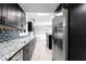Modern kitchen with granite counters, stainless steel appliances, and backsplash at 101 30Th N Ave, St Petersburg, FL 33704