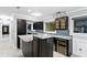 Beautiful kitchen features dark cabinetry, granite countertops, mosaic backsplash and stainless steel appliances at 101 30Th N Ave, St Petersburg, FL 33704