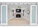 Bright living room featuring fireplace, mounted TV, and sliding glass barn doors at 101 30Th N Ave, St Petersburg, FL 33704
