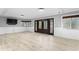 Large open living room featuring hardwood floors, wainscoting, and exterior access at 101 30Th N Ave, St Petersburg, FL 33704