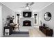 Cozy living room featuring a brick fireplace, ceiling fan, and built-in shelving at 101 30Th N Ave, St Petersburg, FL 33704
