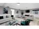 A bright living room featuring modern decor, wainscoting, neutral paint and ample natural light at 101 30Th N Ave, St Petersburg, FL 33704