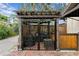 Enclosed patio area features a brick floor, pergola, and an iron gate at 101 30Th N Ave, St Petersburg, FL 33704