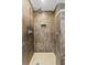 Elegant walk-in shower with brown marble-style tile and a rain shower head at 101 30Th N Ave, St Petersburg, FL 33704