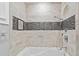Modern tiled shower featuring a built-in bench and contrasting mosaic tile accent stripe at 101 30Th N Ave, St Petersburg, FL 33704