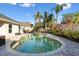 Inviting backyard pool surrounded by lush tropical foliage creating a private oasis at 10340 Lightner Bridge Dr, Tampa, FL 33626