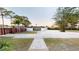 Spacious backyard with grass, gravel, stepping stones, and an outer perimeter privacy fence at 10787 Oak Ne St, St Petersburg, FL 33716