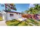 The backyard features a minimalist modern style with a privacy fence, and lush green grass at 10787 Oak Ne St, St Petersburg, FL 33716