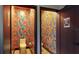 Eclectic toilet rooms with vibrant floral wallpaper and modern fixtures creates a unique and playful atmosphere at 10787 Oak Ne St, St Petersburg, FL 33716