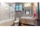 Contemporary bathroom featuring a bathtub with a shower, a stylish vanity, and neutral colors at 10787 Oak Ne St, St Petersburg, FL 33716