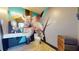 Modern bathroom with a sleek floating vanity, contemporary fixtures, and eye-catching graffiti floral wall art at 10787 Oak Ne St, St Petersburg, FL 33716