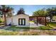 Picture of the exterior back of the home featuring a pergola-covered patio and lush, green lawn at 10787 Oak Ne St, St Petersburg, FL 33716