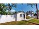 Exterior of the property with a white fence, minimalist modern style and landscaping at 10787 Oak Ne St, St Petersburg, FL 33716