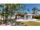 Stunning exterior showcasing a charming patio area with a stylish pergola and lush bamboo accents at 10787 Oak Ne St, St Petersburg, FL 33716