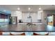 Kitchen with stainless steel appliances, white cabinetry, black countertops, and a spacious island at 10787 Oak Ne St, St Petersburg, FL 33716