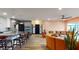 Open concept living area with modern decor, wood floors, and seamless flow to the kitchen at 10787 Oak Ne St, St Petersburg, FL 33716