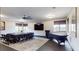 Spacious meeting room with modern lighting, ceiling fan, TV, large windows and dark table, creating professional environment at 10787 Oak Ne St, St Petersburg, FL 33716