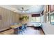 Bright office space features wood accent wall, modern lighting, ceiling fan, and a large window for ample natural light at 10787 Oak Ne St, St Petersburg, FL 33716