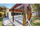 Outdoor pergola-covered patio attached to the house, enhanced by bamboo and lush green landscaping at 10787 Oak Ne St, St Petersburg, FL 33716
