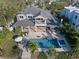 Aerial view of backyard featuring a luxurious pool and spa with patio furniture and a charming two-story home at 1100 Cordova Ne Blvd, St Petersburg, FL 33704