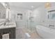Bright bathroom features double sinks, a glass-enclosed shower, a soaking tub, and modern fixtures at 1100 Cordova Ne Blvd, St Petersburg, FL 33704