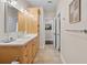 Hall bathroom includes a wooden vanity, modern fixtures, and tile flooring that complements the space at 1100 Cordova Ne Blvd, St Petersburg, FL 33704