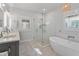 The bathroom is well lit, and it features a soaking tub, a glass-doored shower, and double sinks at 1100 Cordova Ne Blvd, St Petersburg, FL 33704