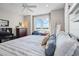 Spacious bedroom with large windows, a comfortable bed, and desk with a view of the waterfront at 1100 Cordova Ne Blvd, St Petersburg, FL 33704