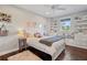 Bright bedroom features a white bed frame, dark wood floors, and a window bench with built-in storage at 1100 Cordova Ne Blvd, St Petersburg, FL 33704