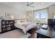 Bedroom with a large window and waterfront views also includes a bookshelf full of books and decor at 1100 Cordova Ne Blvd, St Petersburg, FL 33704