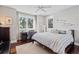 Bedroom with hardwood floors, large windows with a view, and a comfortable desk with an ergonomic chair at 1100 Cordova Ne Blvd, St Petersburg, FL 33704