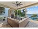 Spacious covered patio featuring comfortable seating, a fireplace, tv, and gorgeous views of the pool and waterway at 1100 Cordova Ne Blvd, St Petersburg, FL 33704