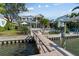 A lovely exterior view from the dock showcasing the home and a lush landscaped yard at 1100 Cordova Ne Blvd, St Petersburg, FL 33704