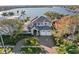 Stunning two-story home showcasing impeccable landscaping, charming porch, and grand curb appeal with a circular driveway at 1100 Cordova Ne Blvd, St Petersburg, FL 33704