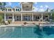 A back exterior home view featuring a large swimming pool, covered porch and a balcony at 1100 Cordova Ne Blvd, St Petersburg, FL 33704