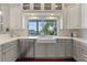 Bright kitchen features custom cabinets, stainless steel appliances and white countertop and a large sink with a view of the water at 1100 Cordova Ne Blvd, St Petersburg, FL 33704