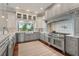 Gourmet kitchen boasts custom cabinets, modern appliances, and an airy window overlooking the scenic backyard at 1100 Cordova Ne Blvd, St Petersburg, FL 33704