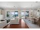 Open living room and dining area with hardwood floors and sliding glass doors to waterfront view at 1100 Cordova Ne Blvd, St Petersburg, FL 33704