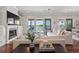 Bright living area with waterfront views, a fireplace, and an open floor plan to the dining area at 1100 Cordova Ne Blvd, St Petersburg, FL 33704