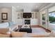 Cozy living room featuring a fireplace with built-ins and sliding doors to a pool view at 1100 Cordova Ne Blvd, St Petersburg, FL 33704
